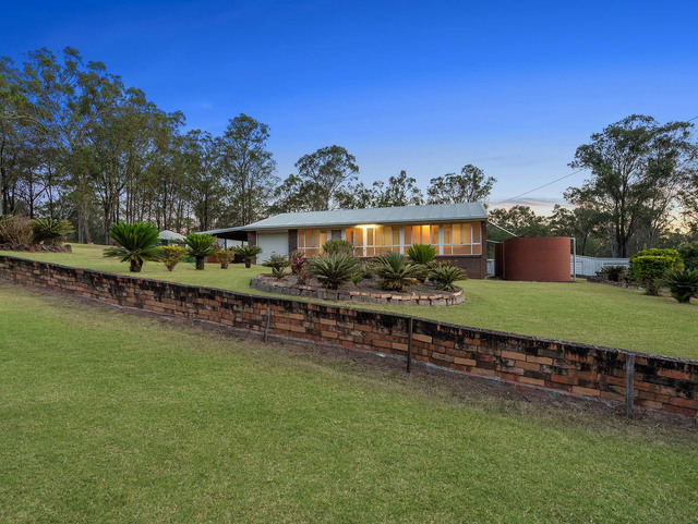 Flat and flood free acreage with well-positioned home